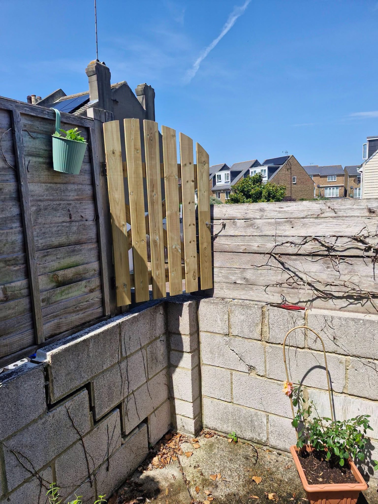 New softwood picket side gate installed onto existing fence post