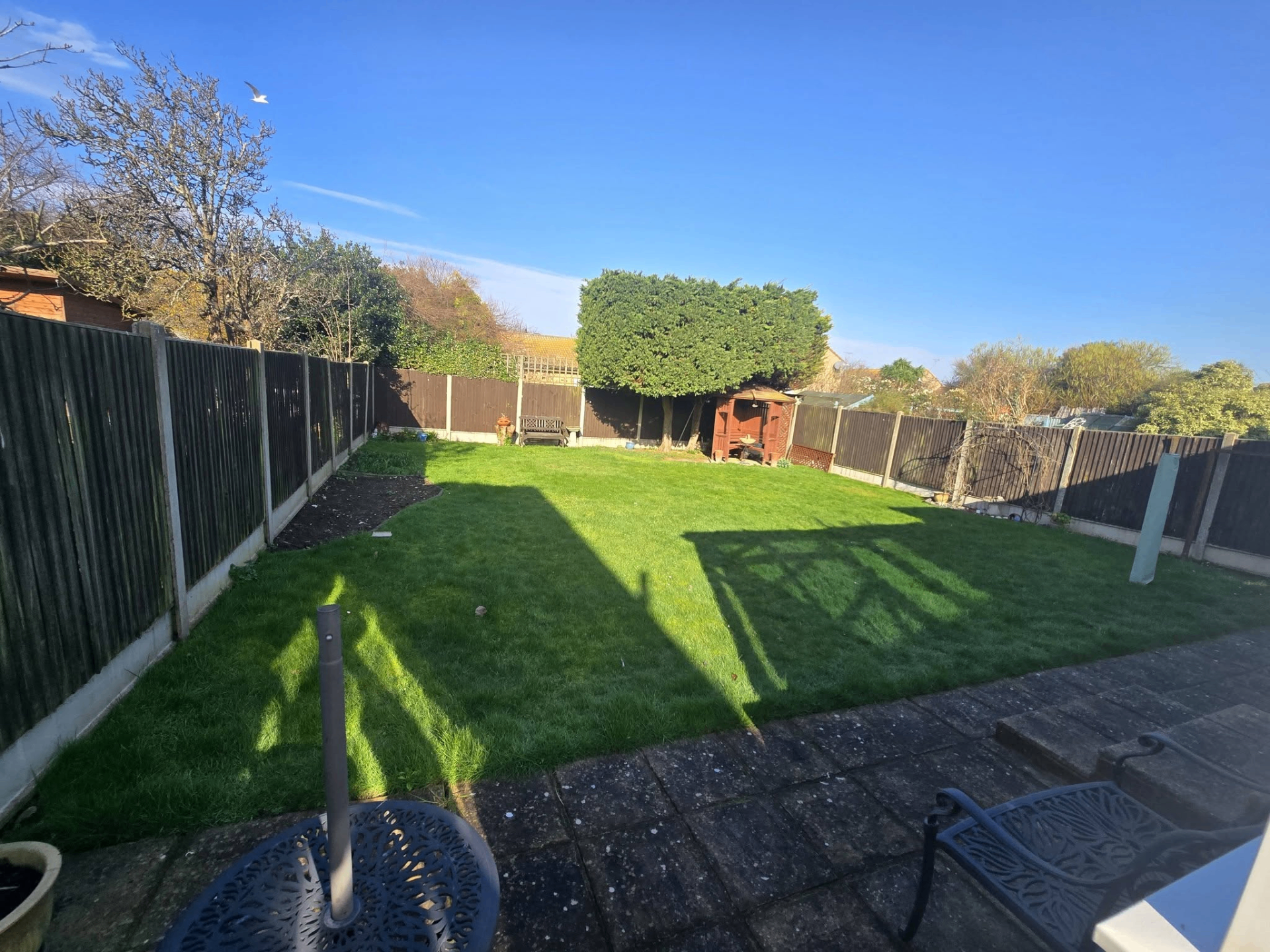 Well-kept lawn and garden maintained by Sam's Garden Services