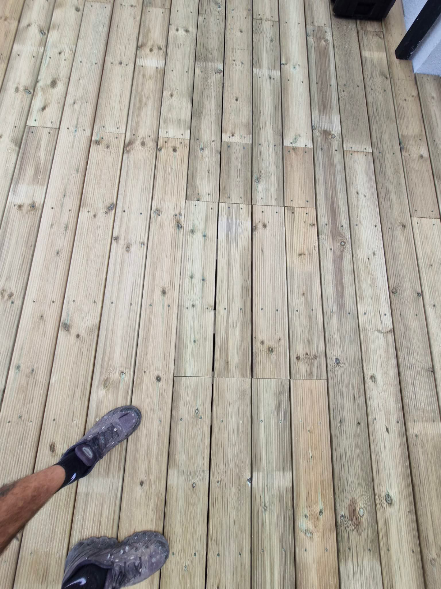 Neatly screwed decking boards with staggered joints and even spacing