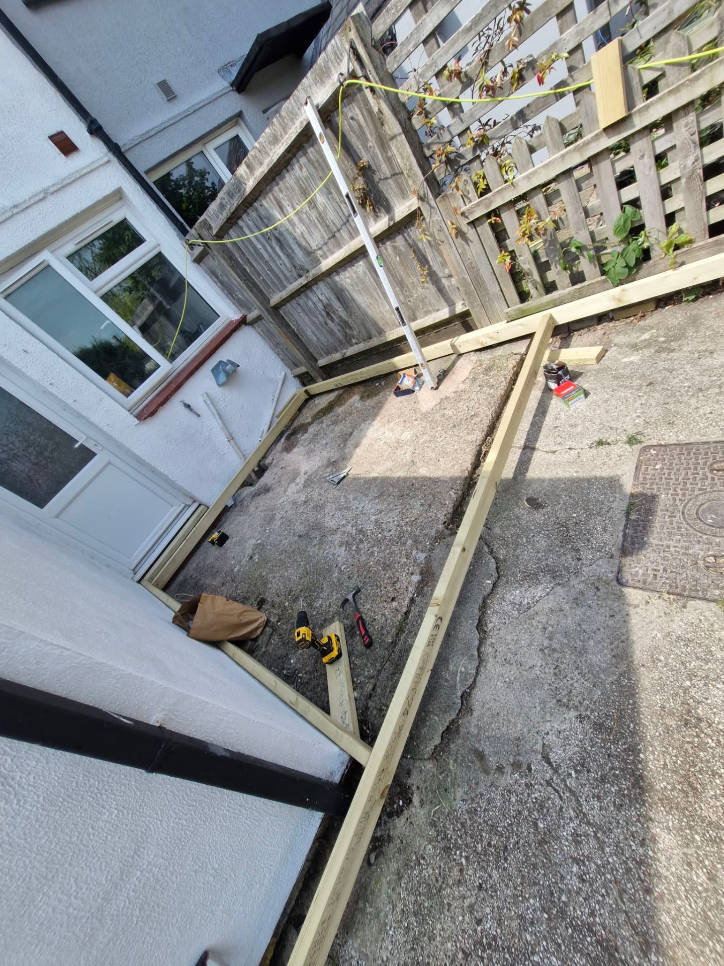 Timber frame being set out and levelled for a raised garden deck