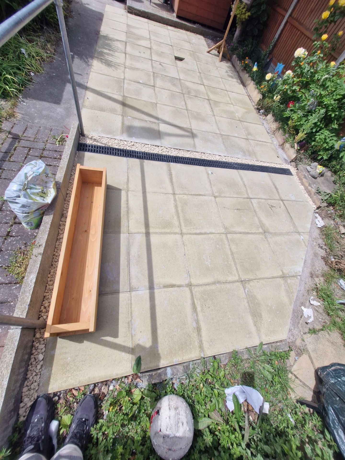 Concrete slab path with linear drainage channel and gravel border