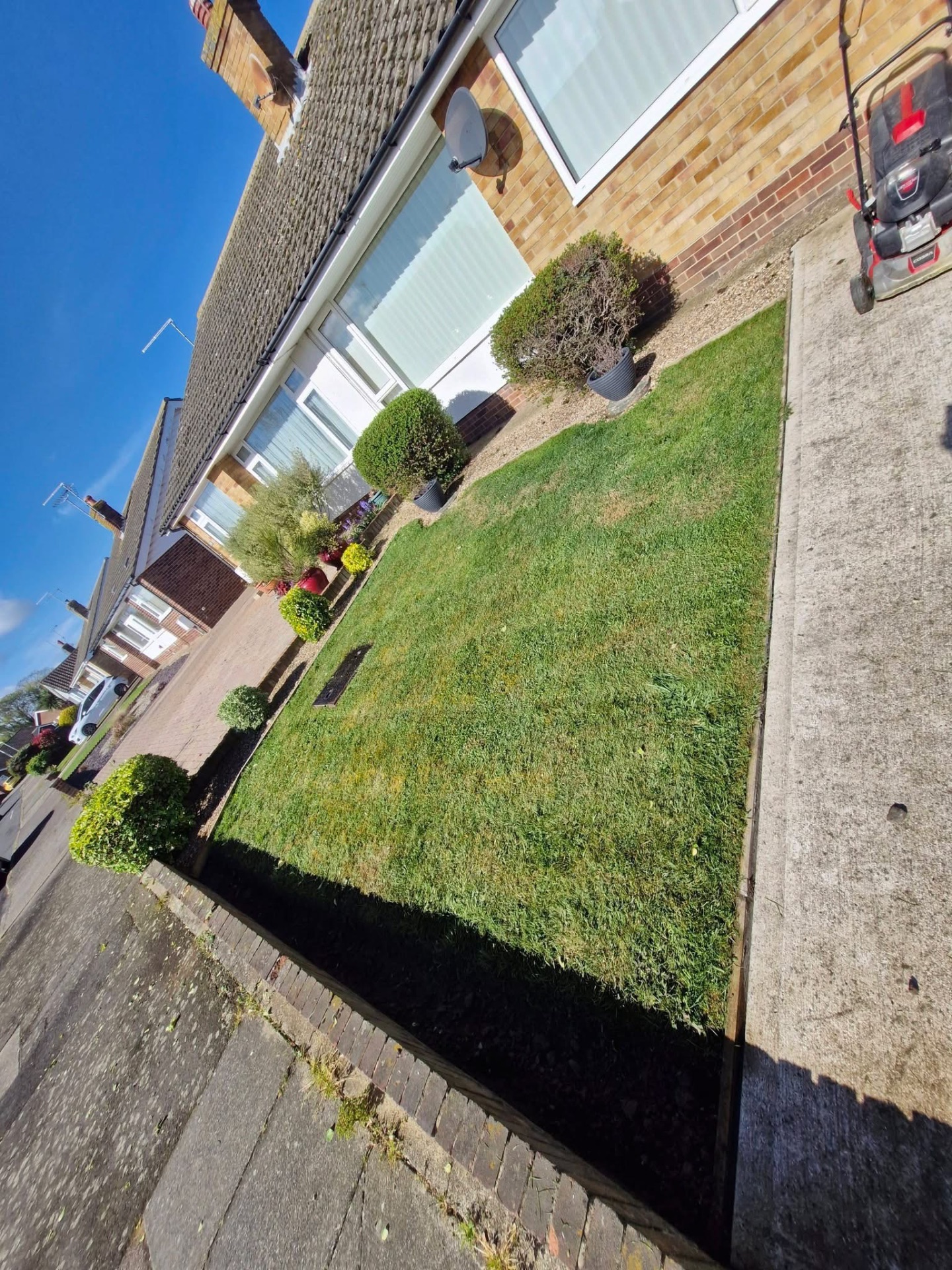 Front lawn freshly mown with edges tidied along path