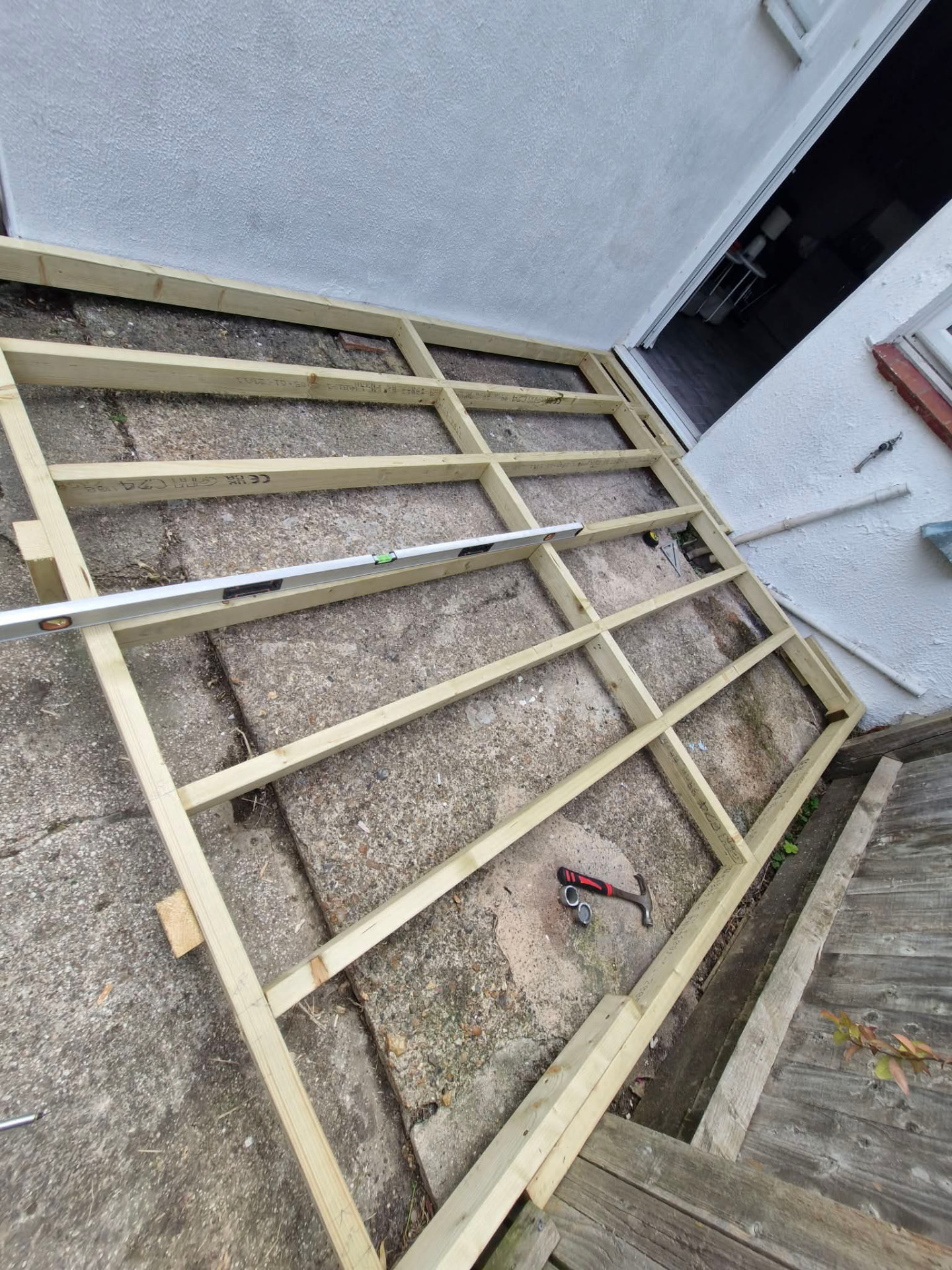Close view of levelled decking joists framed around a manhole cover