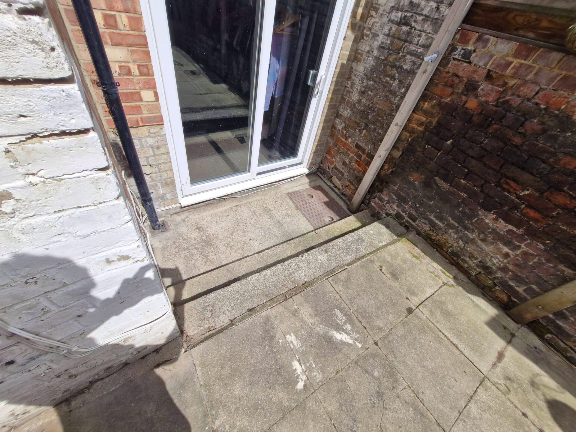 Rear patio steps cleared and swept back to bare slabs
