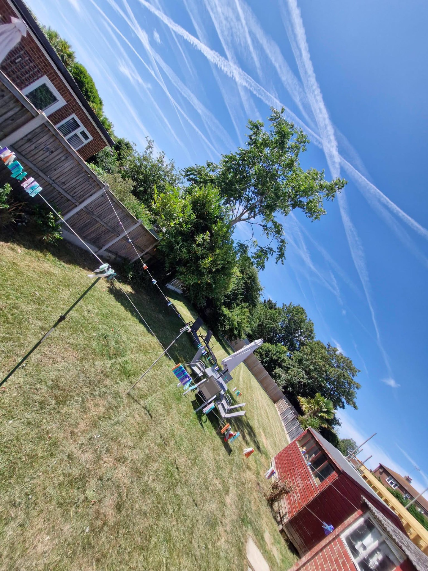 Family back garden mown and tidied around washing line and seating
