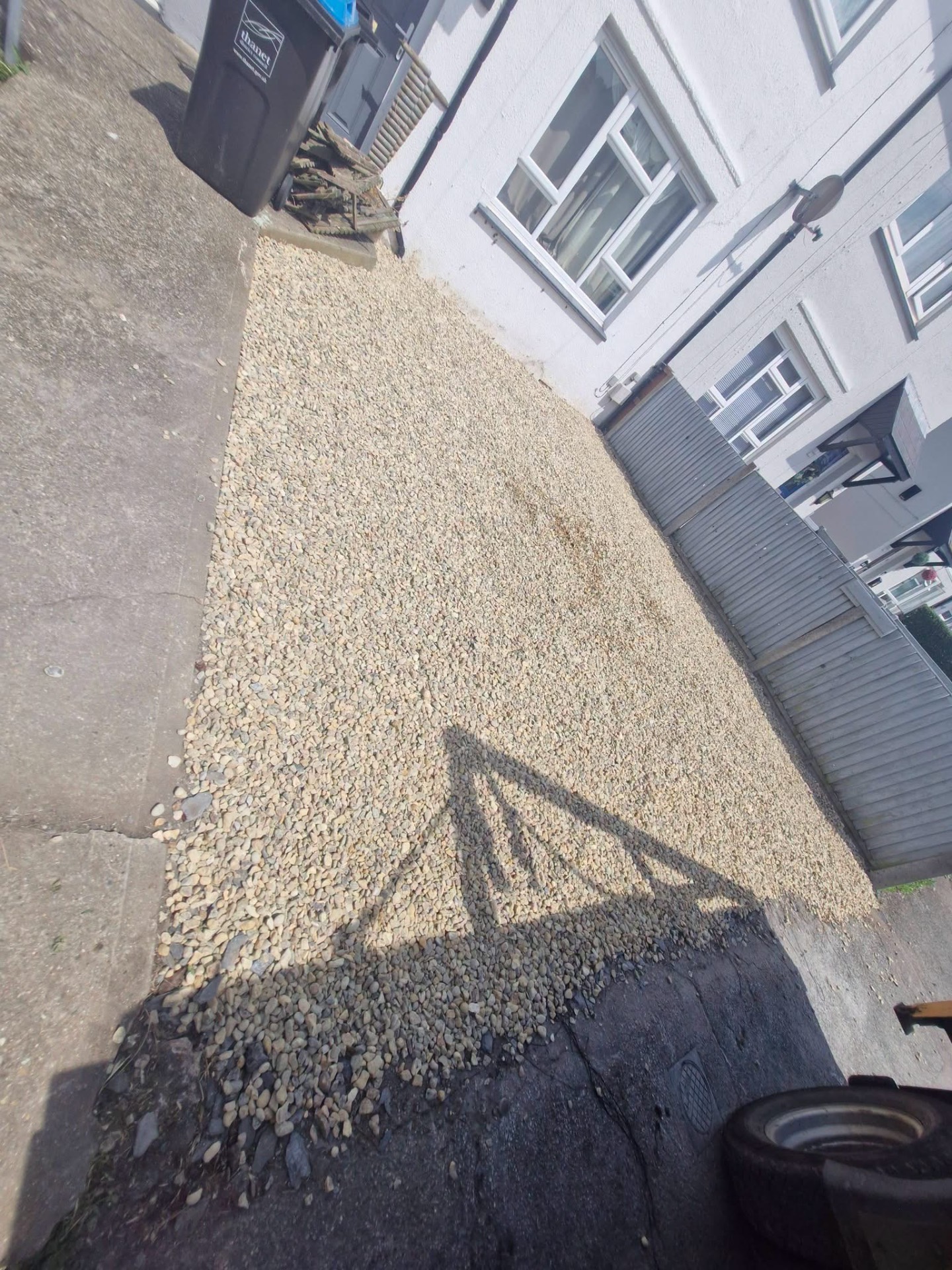 Fresh gravel side path laid alongside property