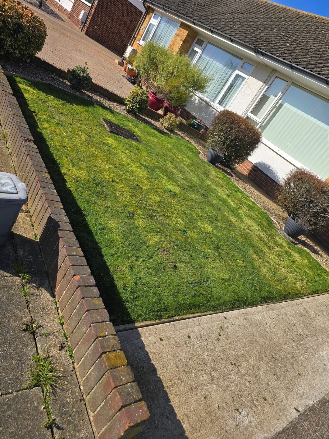 Front lawn cut and edged along brick border and driveway