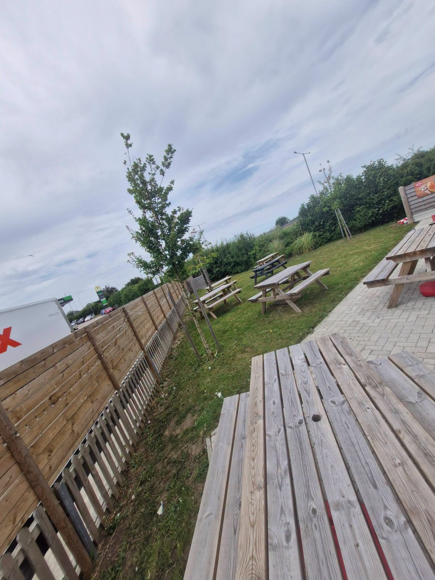 Commercial outdoor seating area with picnic benches and decking